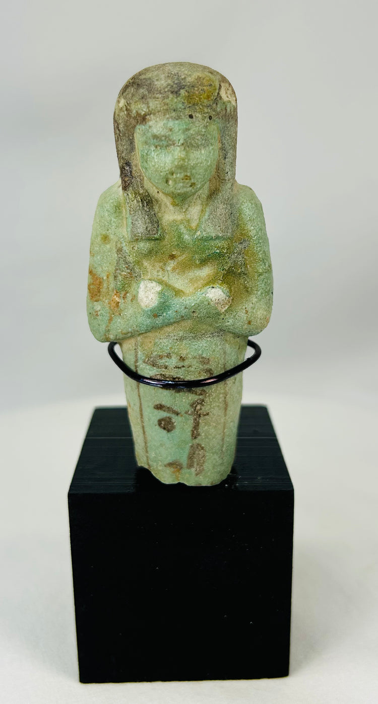 Late Period Egyptian funerary ushabti with crossed arms and agricultural implements