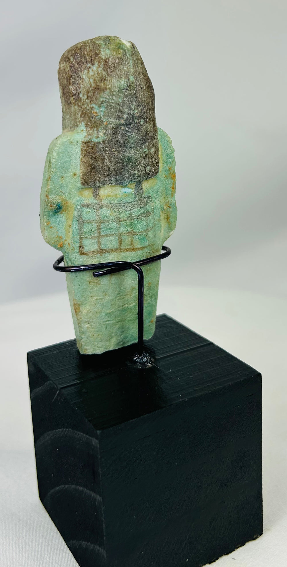 Ancient ushabti figure from Egypt with black painted basket grid and hieroglyphs