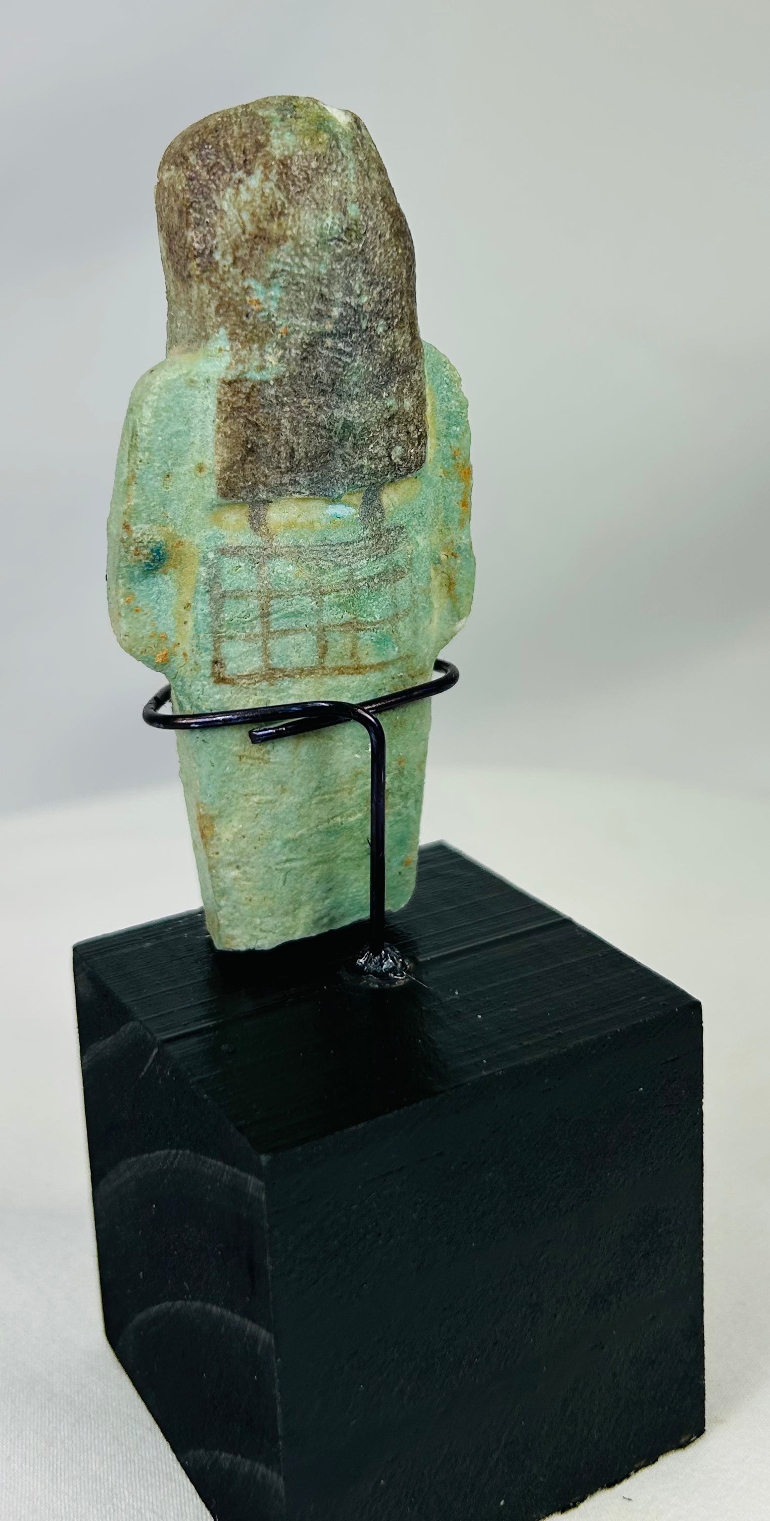 Ancient ushabti figure from Egypt with black painted basket grid and hieroglyphs