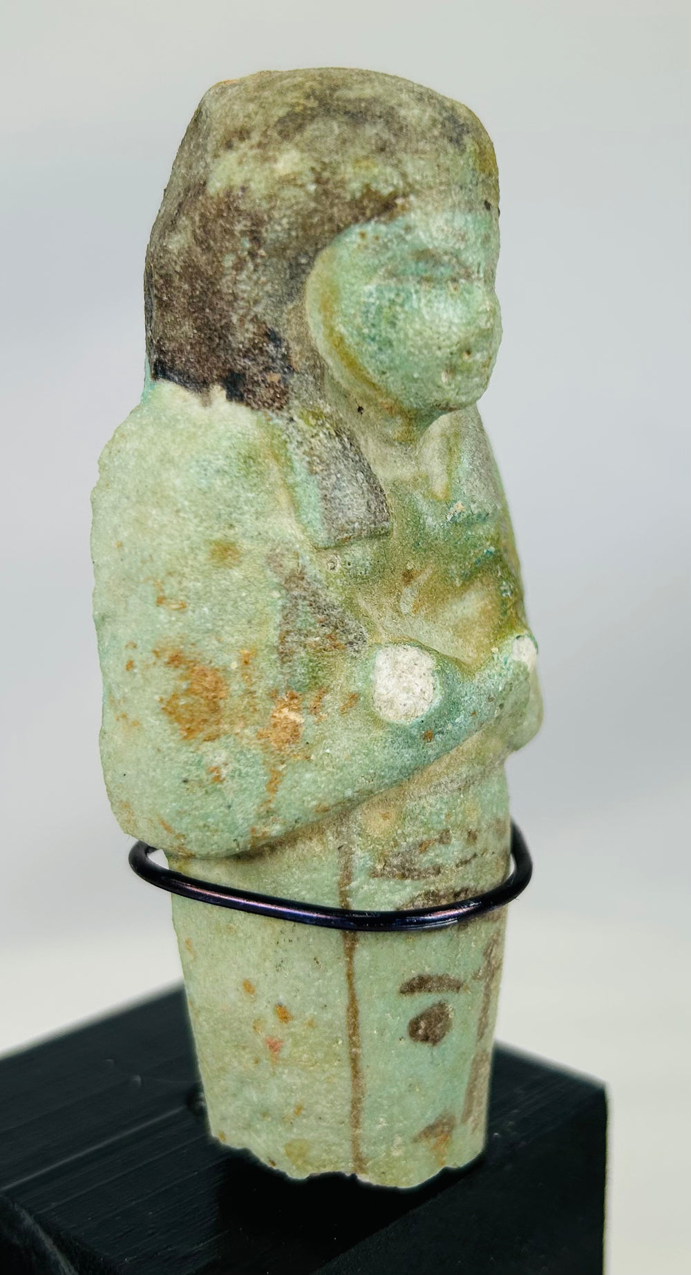 Blue-green faience Egyptian servant figure with traditional wig and crossed arms