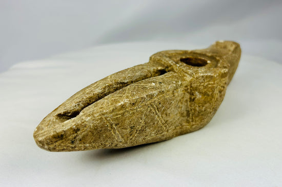 Hand-carved Islamic stone oil lamp showing deep reservoir and wear