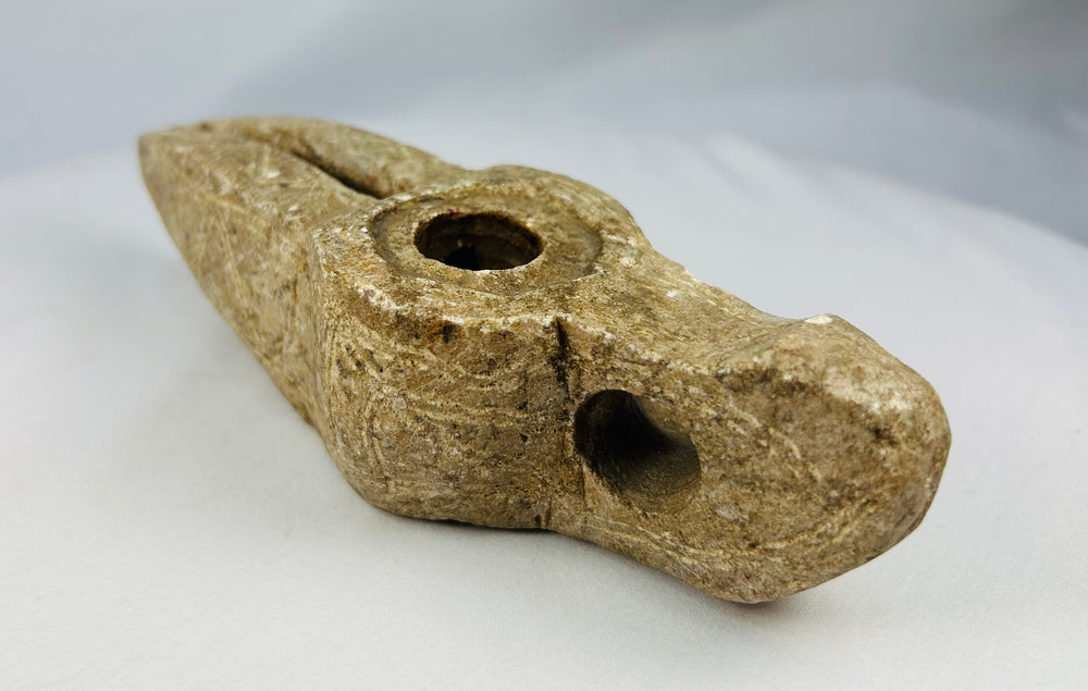 Stone oil lamp from Islamic world displaying mineral deposits and aging