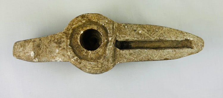 Ancient Islamic lamp with elongated wick channel and carved designs