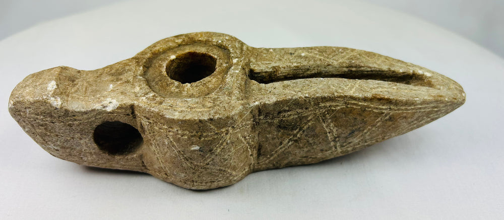 Middle Eastern carved stone lamp showing authentic archaeological surface