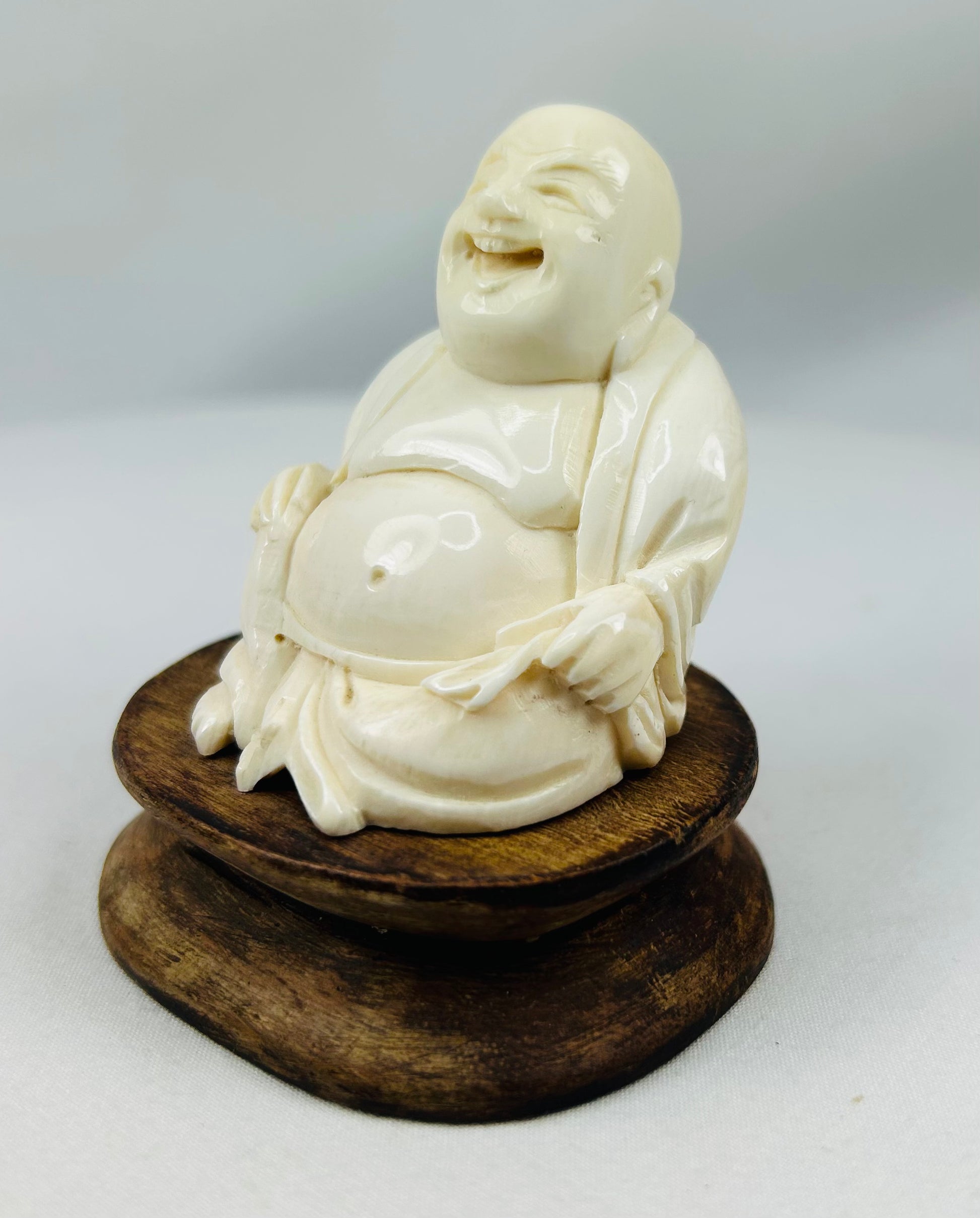 East Asian Budai ivory-style figurine symbolizing happiness and prosperity