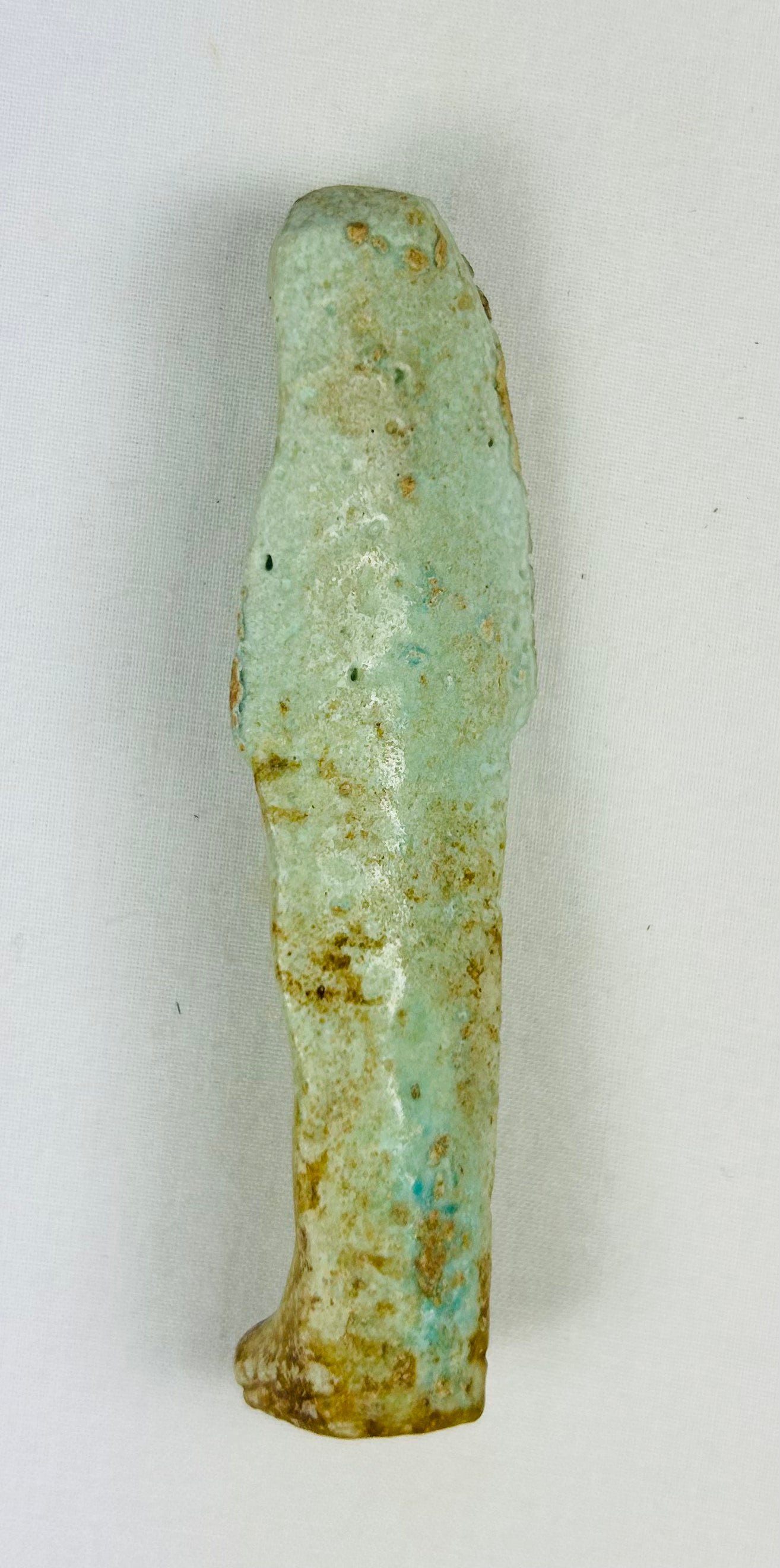 Museum-style Ushabti relic with weathered glaze, sandy toning, and spiritual symbolism