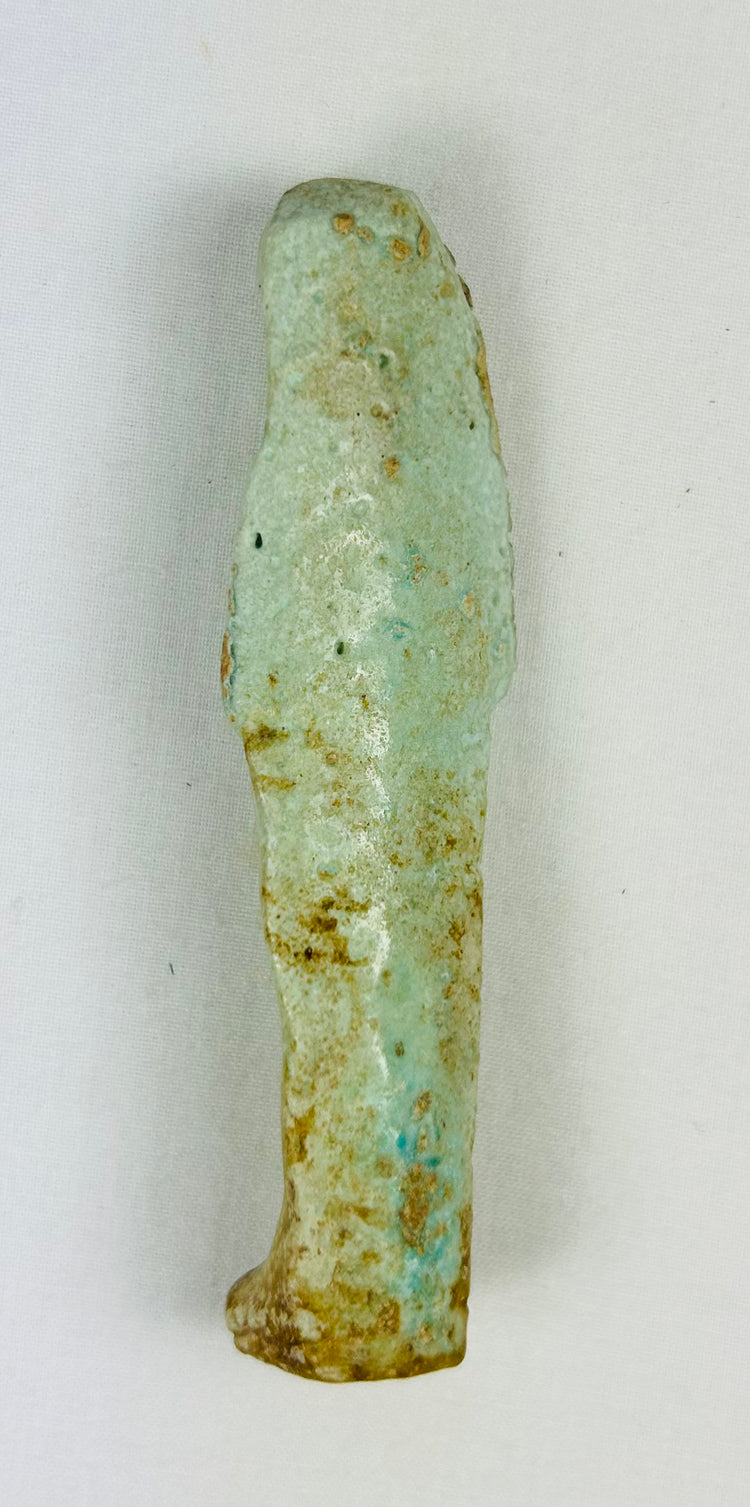Museum-style Ushabti relic with weathered glaze, sandy toning, and spiritual symbolism