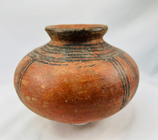 Antique African pottery bowl with geometric banding and warm earthen tone