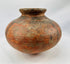 Handmade African clay vessel showing natural firing marks and patina