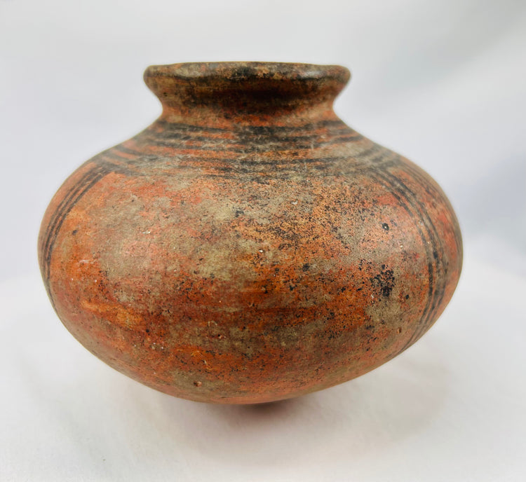 Handmade African clay vessel showing natural firing marks and patina