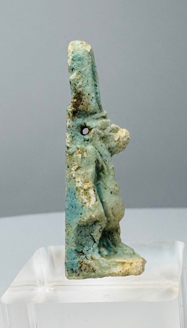 Detailed view of burial deposits, encrustation and ancient glaze wear on Egyptian faience