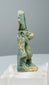 Detailed view of burial deposits, encrustation and ancient glaze wear on Egyptian faience