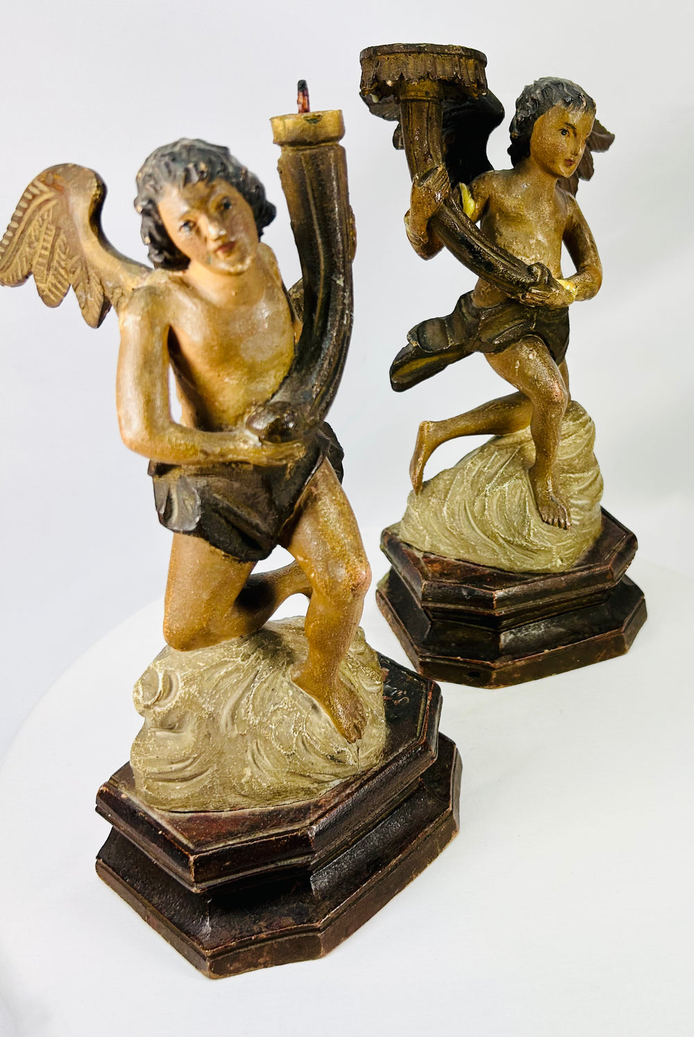 Pair of 18th–19th century carved wooden angels on octagonal devotional bases