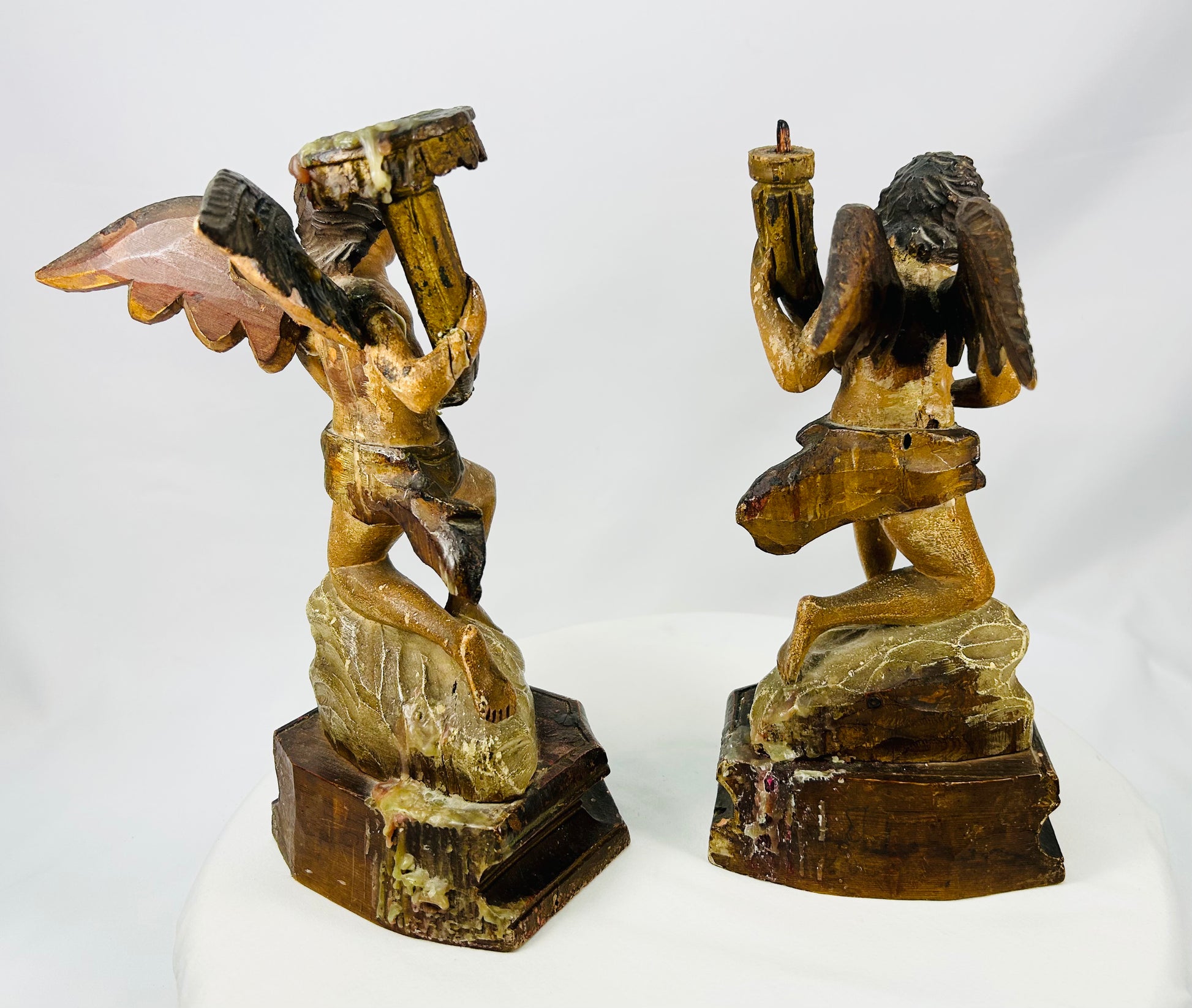 Antique religious wooden angel sculptures with expressive faces and wings