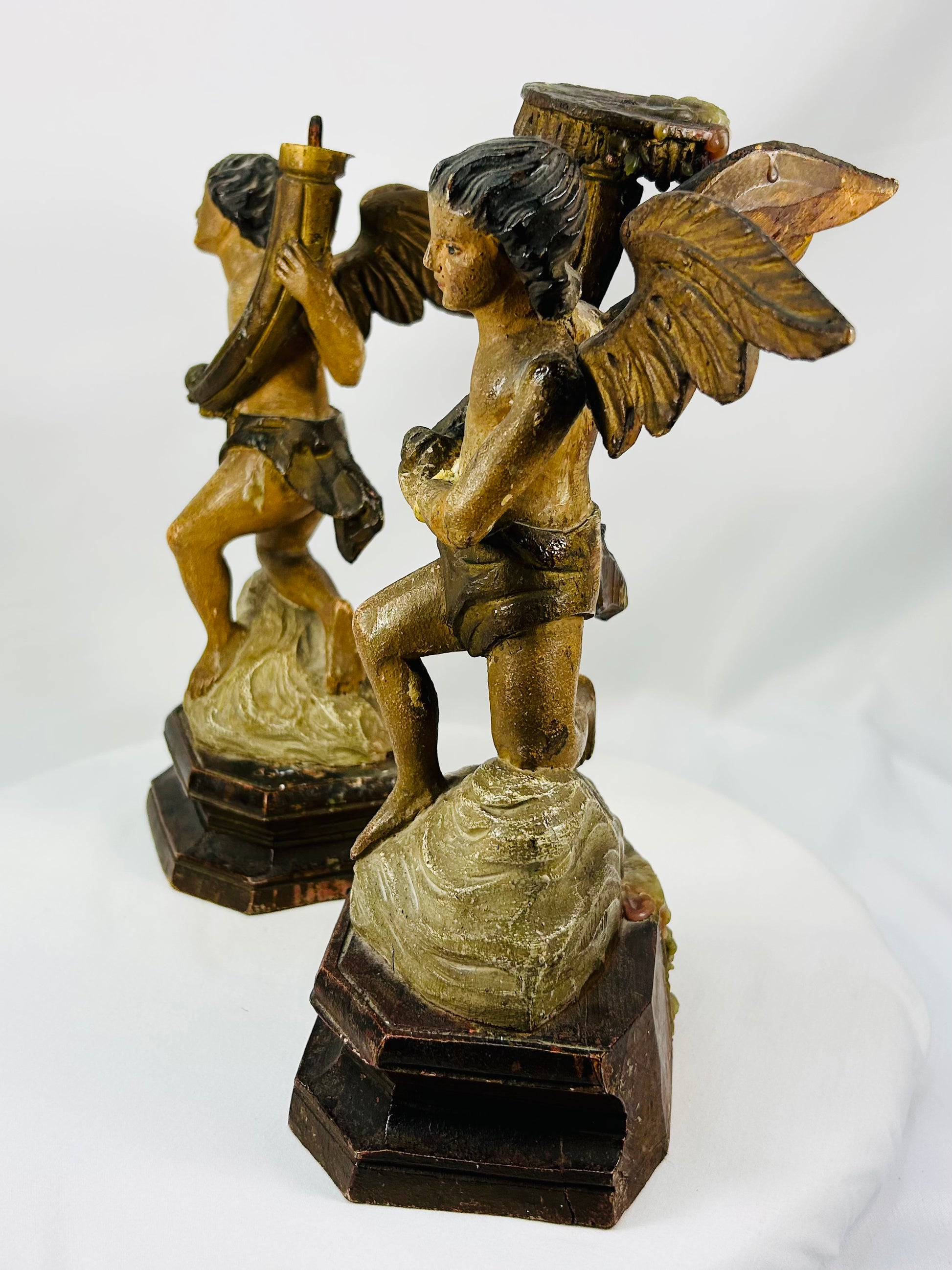 Hand-carved devotional angel figures with traces of original paint and gold gilding