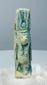 Rear detail of blue-green glaze preserved within the recessed areas of a Taweret figure