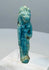 Reverse view of a Late Period faience amulet showing extensive blue-green glaze remnants