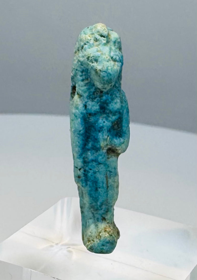Reverse view of a Late Period faience amulet showing extensive blue-green glaze remnants