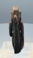 Close view of a possible wadjet-eye emblem held by a lioness-headed goddess