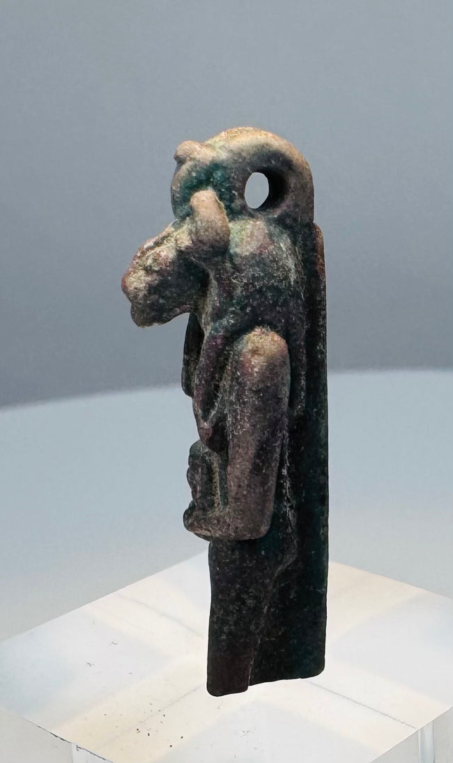 Lower view showing old chipping and losses along the garment and integral base