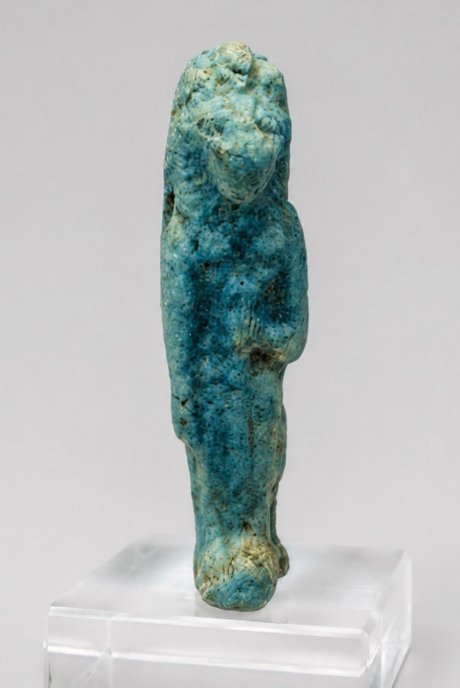 Front view of an Egyptian lioness-headed goddess amulet with surviving turquoise-blue glaze