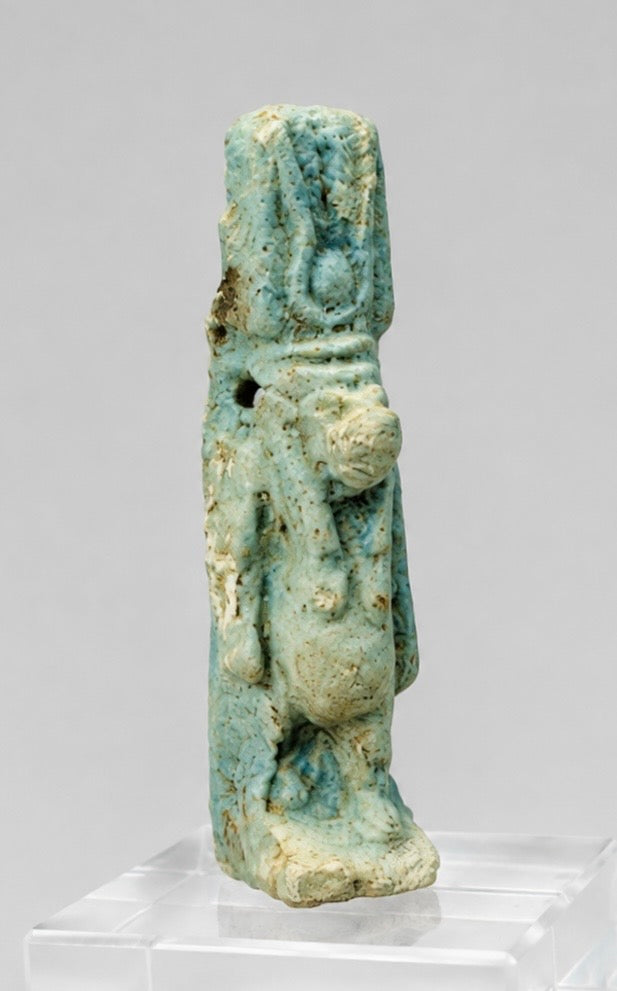 Front view of an ancient Egyptian Taweret amulet with surviving blue-green faience glaze