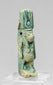 Front view of an ancient Egyptian Taweret amulet with surviving blue-green faience glaze