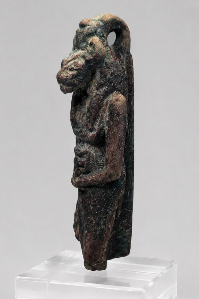 Front view of an Egyptian lioness-headed goddess amulet with dark burial patina
