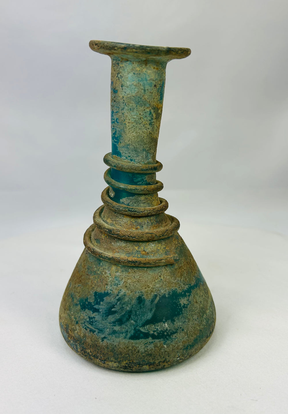 Authentic Roman glass bottle circa 1st–3rd century CE with encrusted turquoise coloration