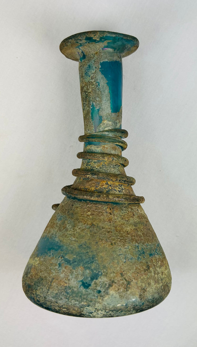 Well-preserved ancient Roman glass vessel with iridescent patina and historic presence