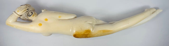 Close-up of age-related cracks, separation lines, surface wear and old repairs across the figure
