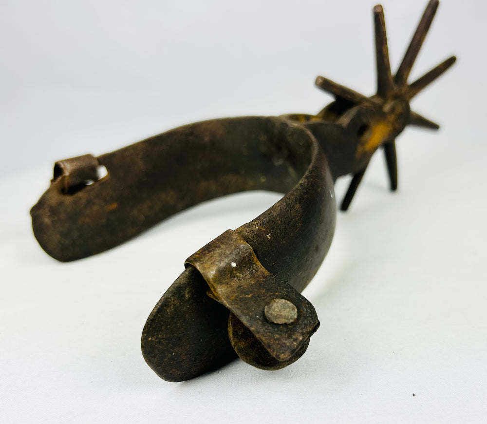 Antique forged iron cowboy spurs with frontier riding heritage and character