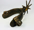 Antique forged iron cowboy spurs with frontier riding heritage and character