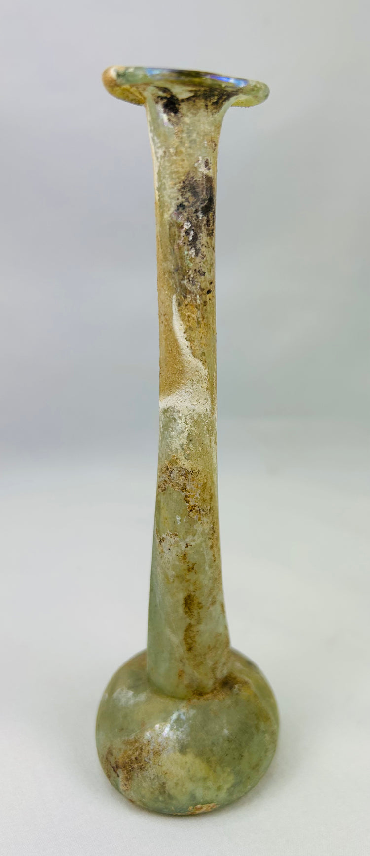 Museum-quality Roman glass unguentarium displaying iridescence and burial weathering