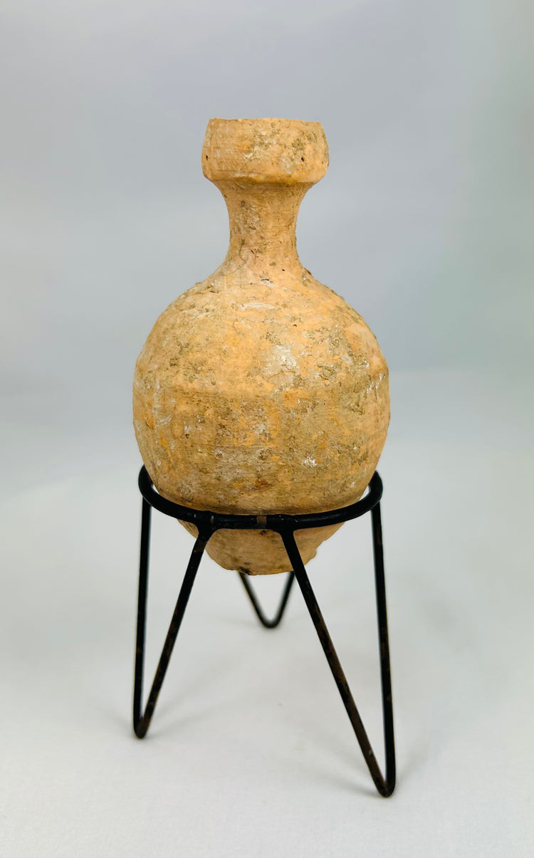 Roman cosmetic and bathing oil bottle with earthen deposits and aged surface
