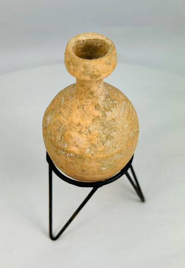 Archaeological Roman ceramic oil vessel showcasing natural mineral accretions