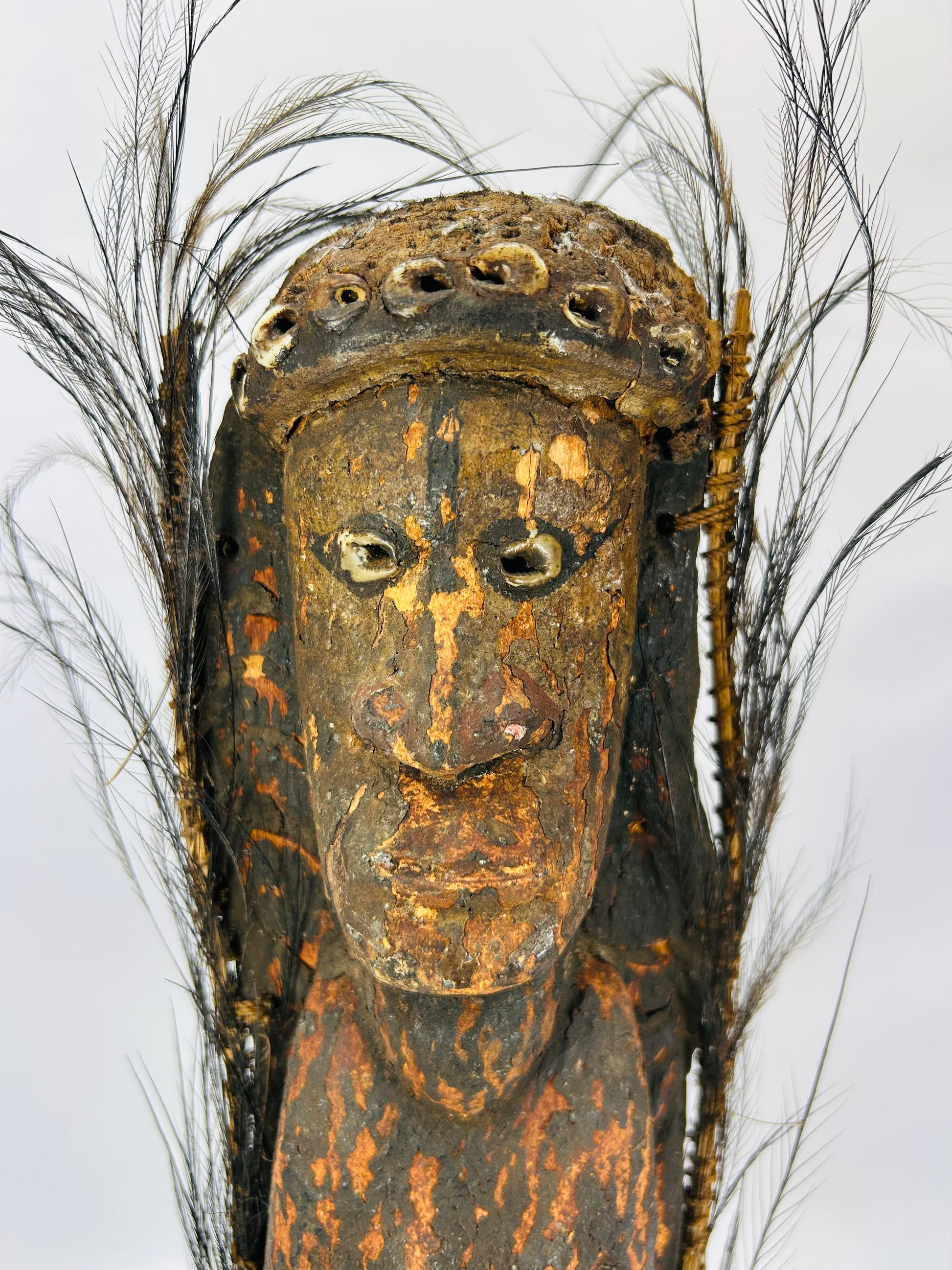 Ethnographic Sepik River wood figure with expressive face, pigments, and aged surface