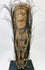Papua New Guinea tribal ancestor carving with natural feathers and ceremonial wear
