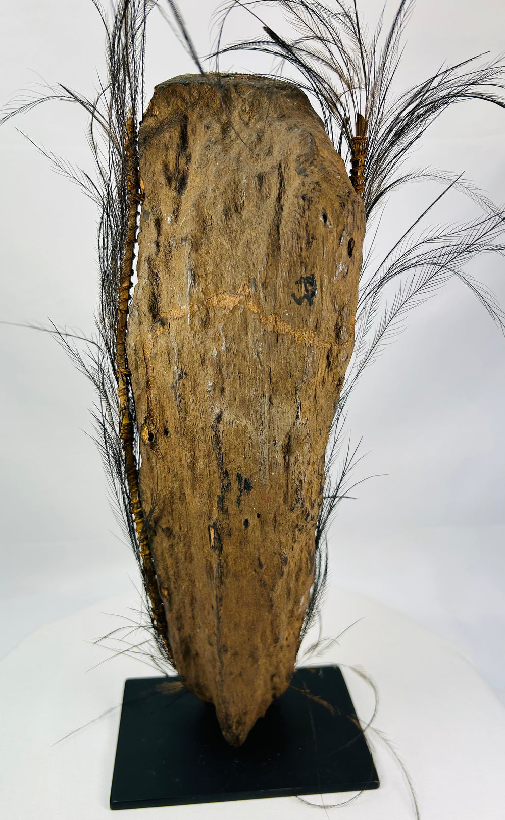 Hand-carved wooden ancestor figure from Papua New Guinea with shell eyes and fiber bindings