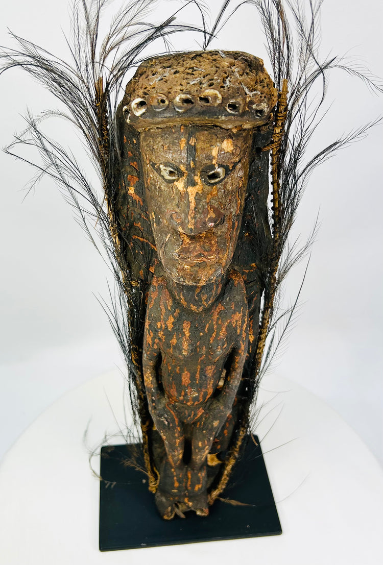 Antique Papua New Guinea carved ancestor figure with cowrie shell inlay and ritual patina