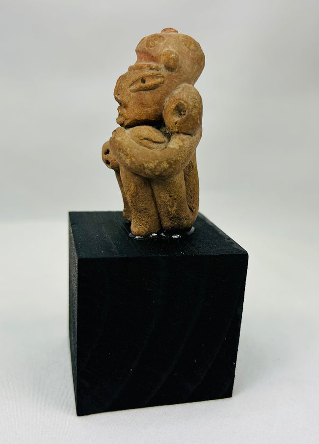 Expressive Pre-Columbian terracotta ancestor figure with stylized facial features and ear ornaments