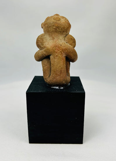West Mexico shaft tomb terracotta sculpture showing contemplative seated posture and reddish clay surface