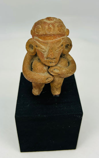Ancient Mesoamerican terracotta figure with ritual seated pose and subtle traces of original pigment