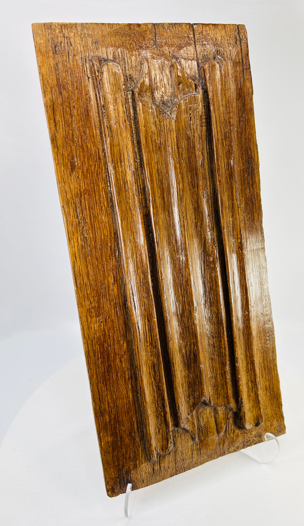 Renaissance-era carved oak panel showing vertical fluting and Gothic tracery details