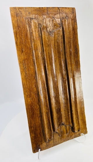 Renaissance-era carved oak panel showing vertical fluting and Gothic tracery details