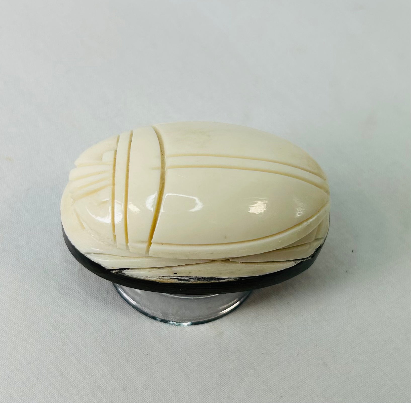 Side view of antique East Asian scarab talisman highlighting smooth polished surface