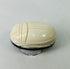 Side view of antique East Asian scarab talisman highlighting smooth polished surface