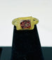 Close-up of 2nd-century Roman bronze ring showing square bezel and red glass stone