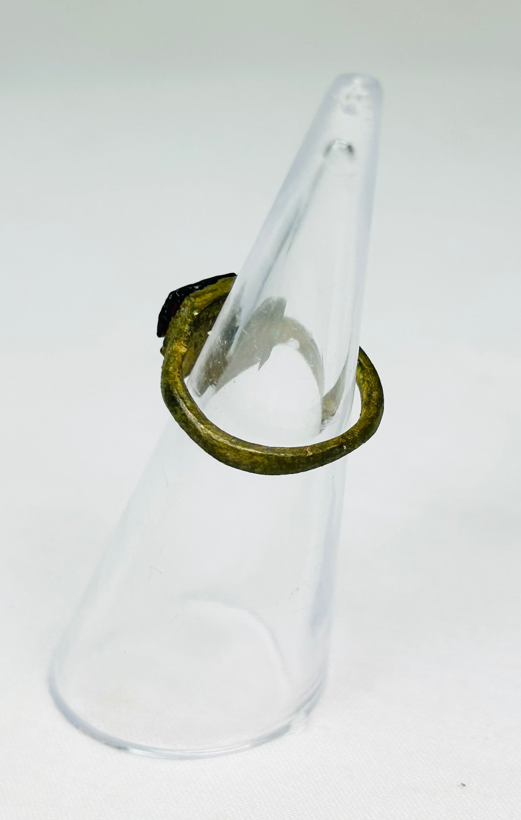 Detailed view of ancient Roman bronze ring showing age wear, cracking, and craftsmanship