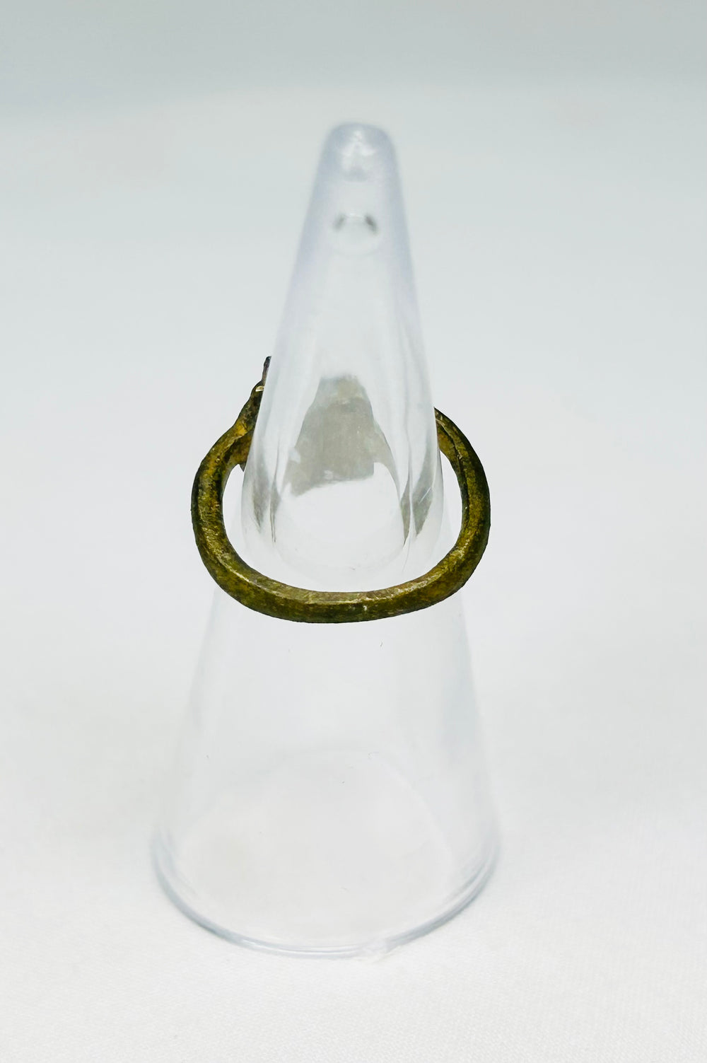 Rear view of ancient Roman bronze ring showing age wear, cracking, and craftsmanship